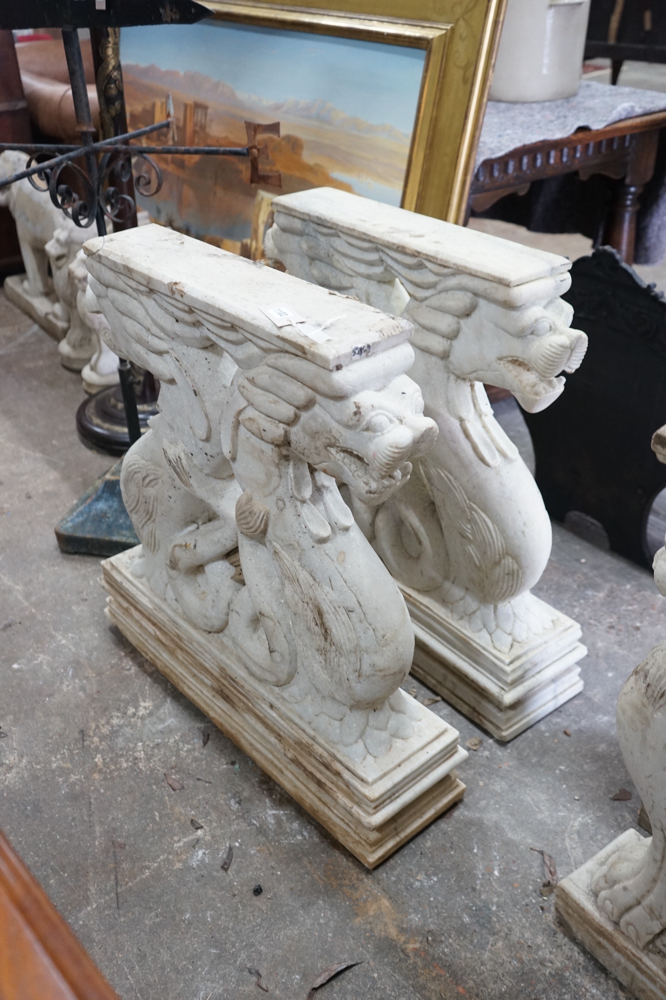 A pair of carved stone serpent table supports, width 75cm, height 78cm